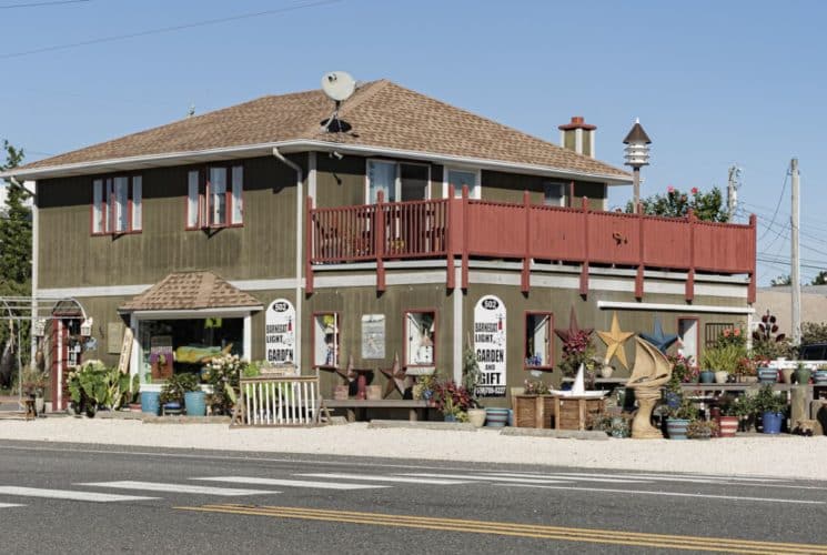 Exterior view of retail garden store with brown siding and white trim