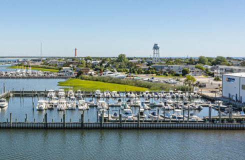 Aerial view of two harbors full of boats in a coastal town