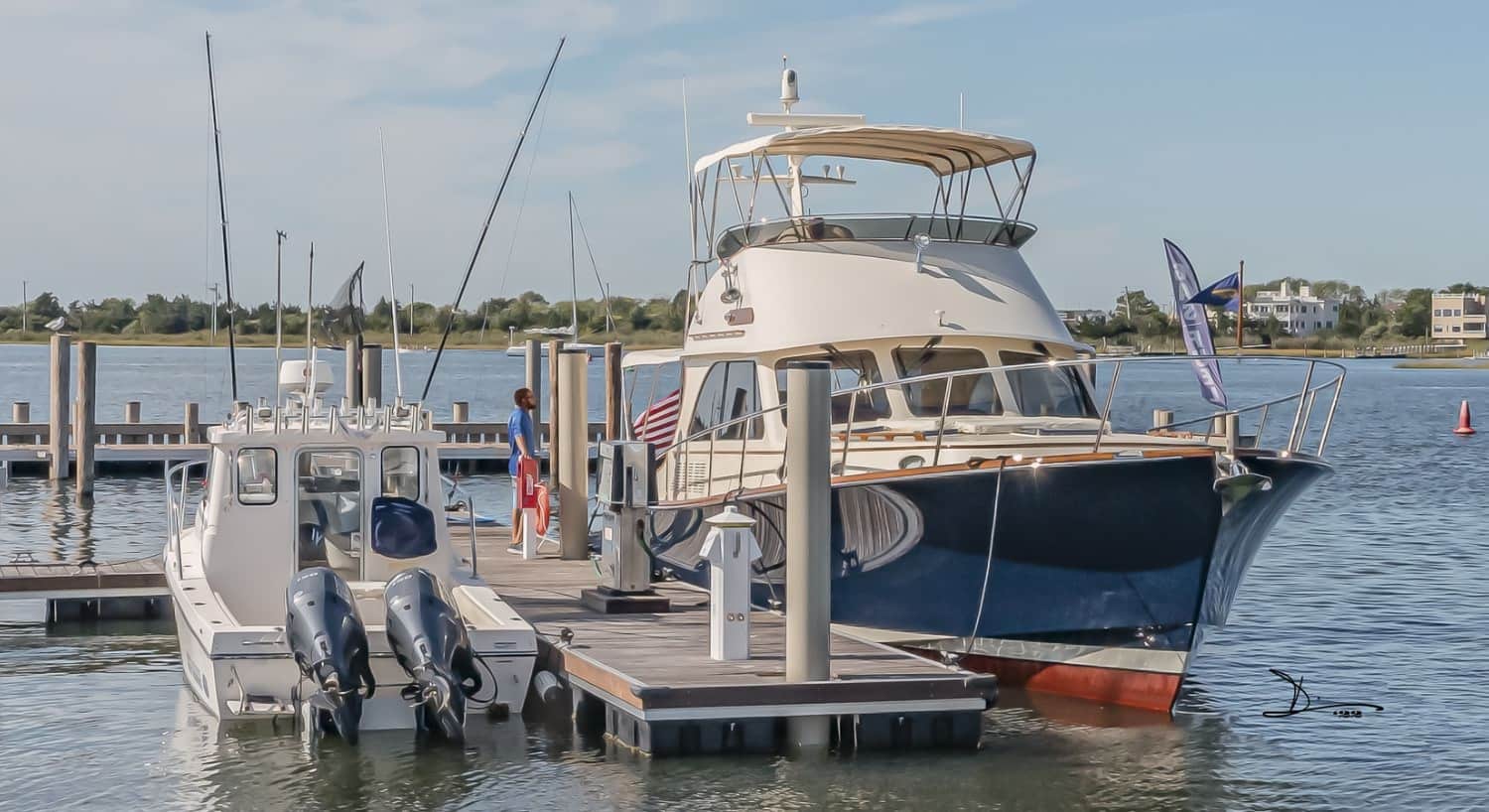 Large blue and white boat in slip in the harbor