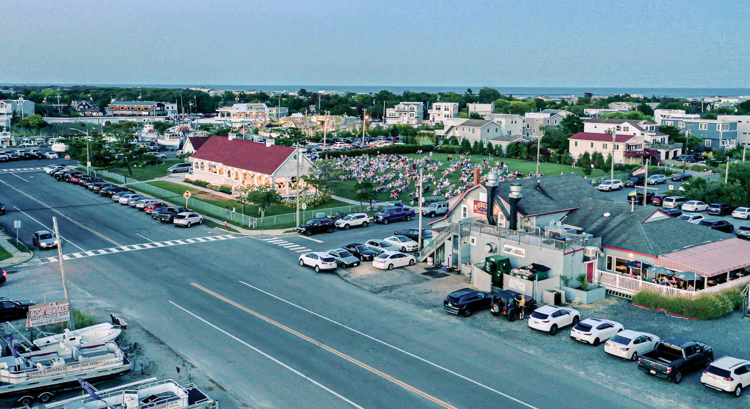 Aerial view of a restaurant and a recreation area full of people enjoying a concert