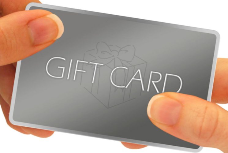 Close up view of gray gift card held by two hands