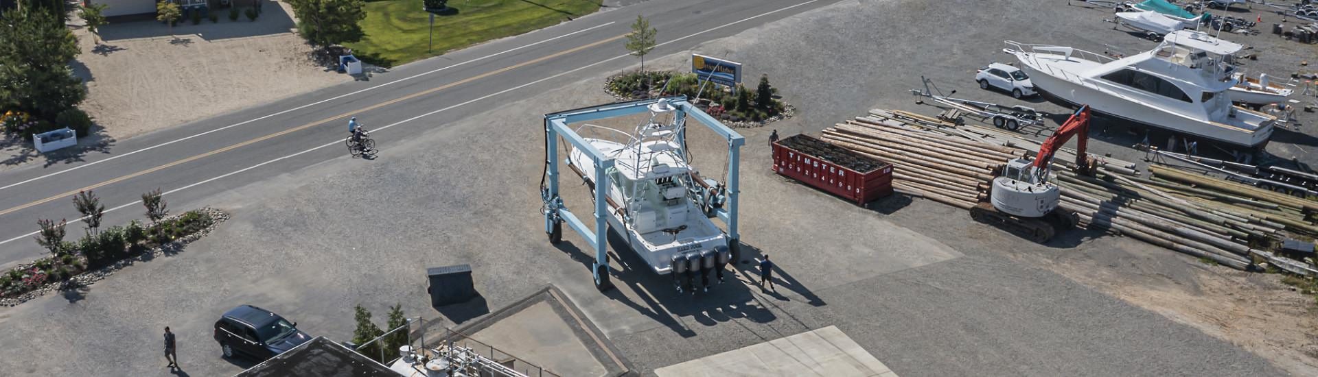 Aerial view of a boat out of the water being moved for service
