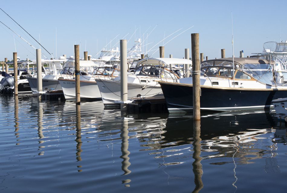 Multiple small boats in slips in the harbor