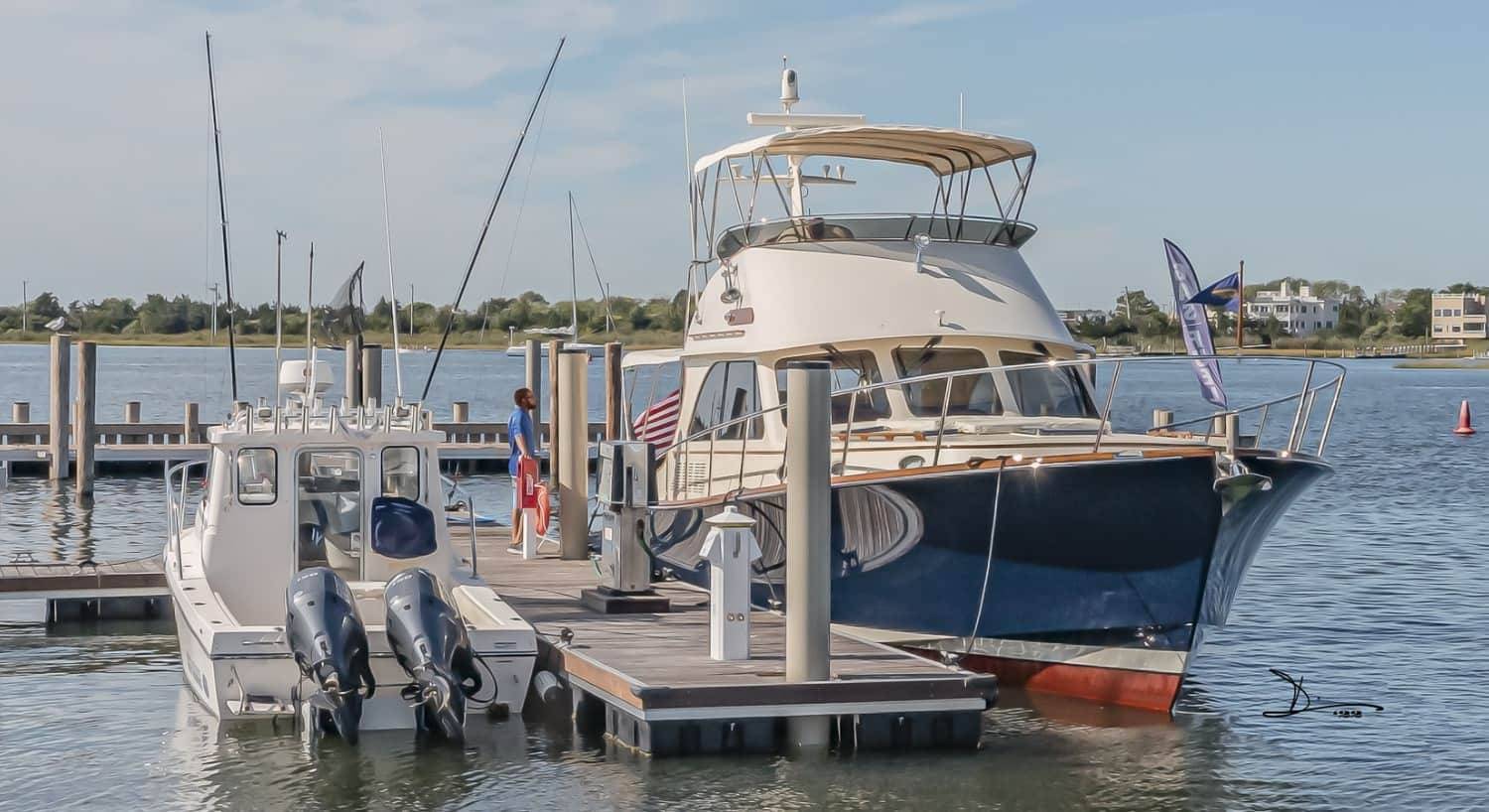 Large blue and white boat in slip in the harbor